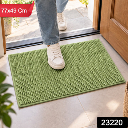 A person's feet in white sneakers stepping onto a green bobble mat, with product dimensions and code overlaid.