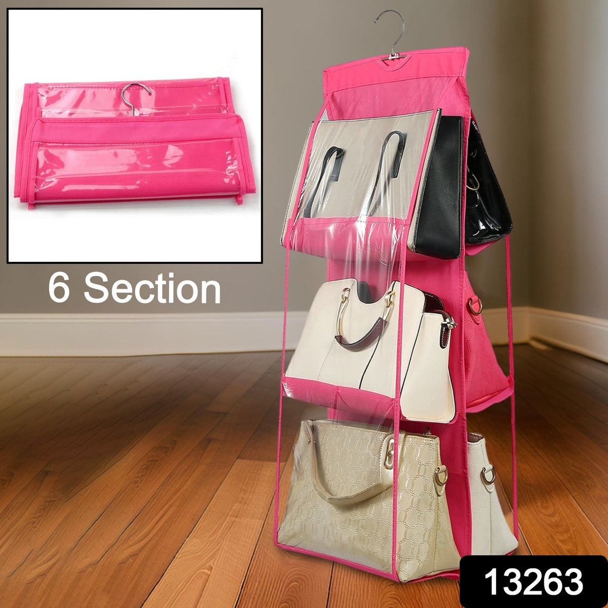 A pink 6-section hanging purse organizer with clear pockets is displayed on a wooden floor.
