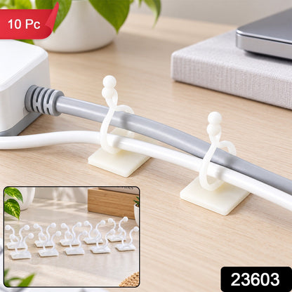 Two white self-adhesive clips securing a grey and a white cable to a light wooden desk, with a small inset of eight – view 2