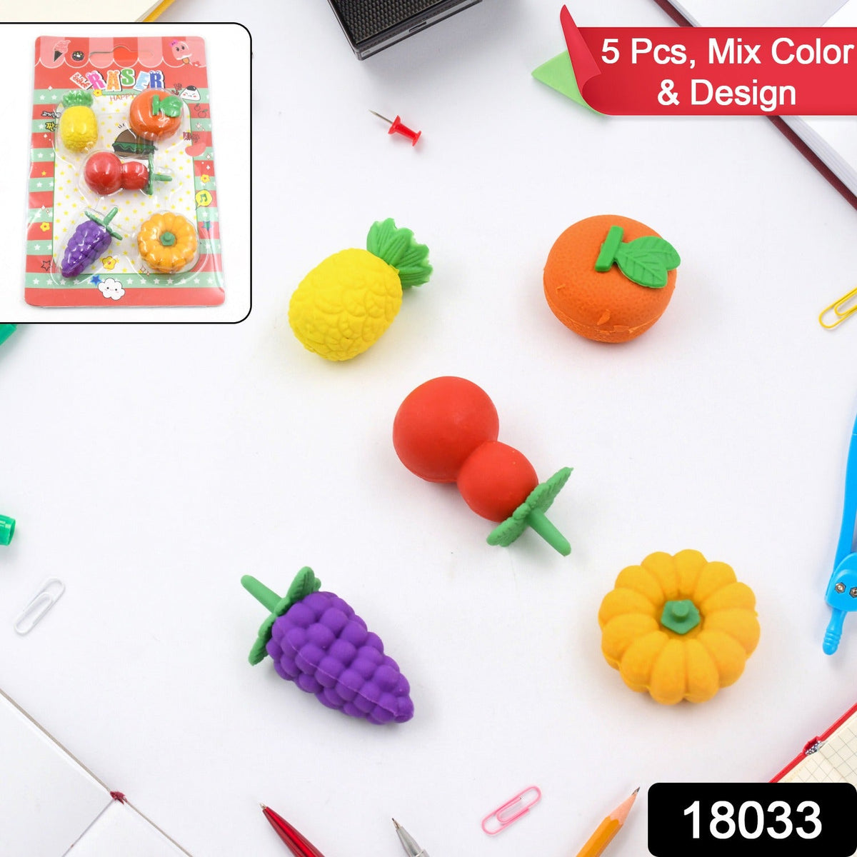 Five fruit-shaped erasers, including pineapple, orange, grapes, cherry, and pumpkin, are displayed on a white surface.