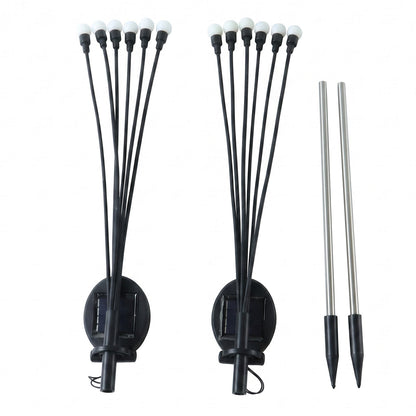 Two solar firefly light units with black stems and white bulbs, along with two silver stakes, on a white background.