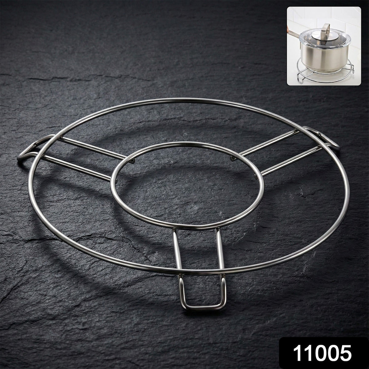 A shiny silver wire hot pot stand rests on a dark slate surface, with a small inset of a pot on the stand.