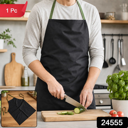 A person in a light grey long-sleeved shirt and a black apron with green straps is slicing a cucumber on a wooden – view 2