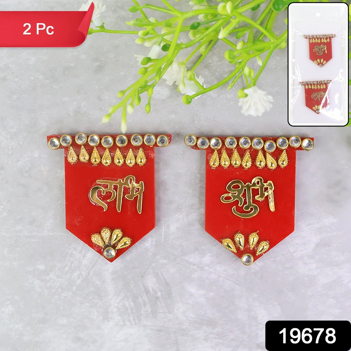Two red Shubh Labh wall hangings with gold and clear stone embellishments, shown on a grey background with green and white