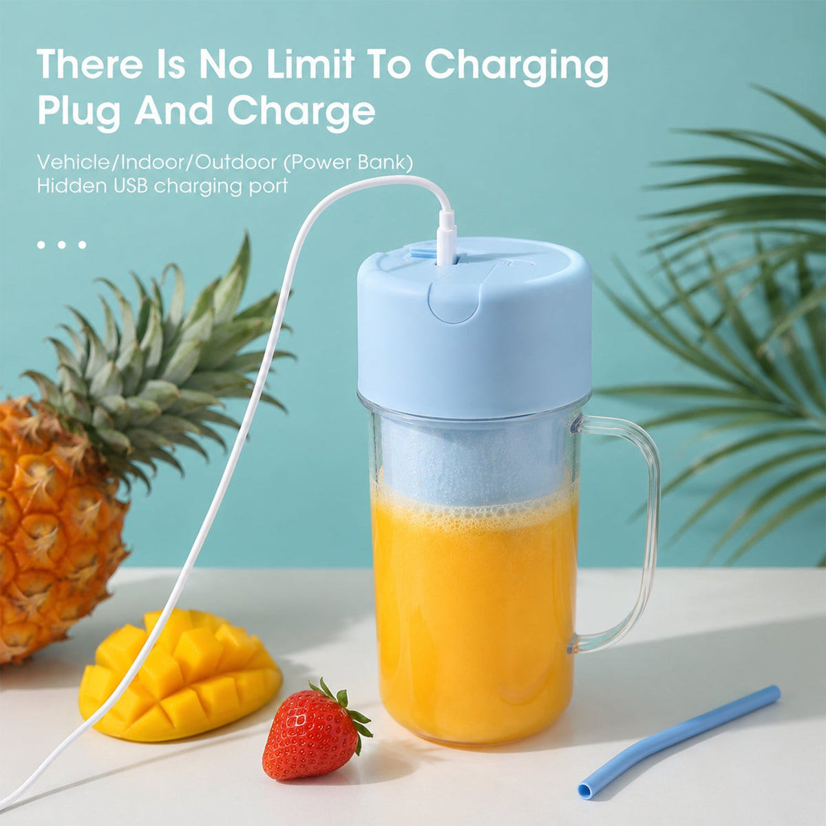 A light blue portable blender with orange juice is charging via a white USB cable next to fruit.