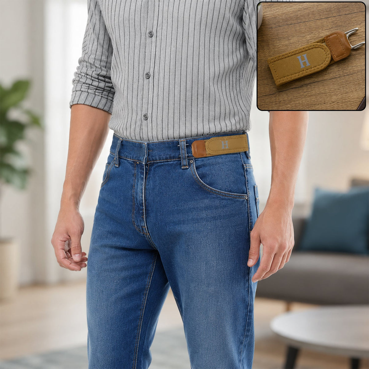 A man in a striped shirt and blue jeans wears a tan buckle-less belt with a silver 'H' on the front, with a close-up of the