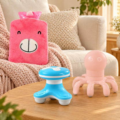 A pink bear hot water bag, a blue body massager, and a pink octopus head massager on a wooden table.