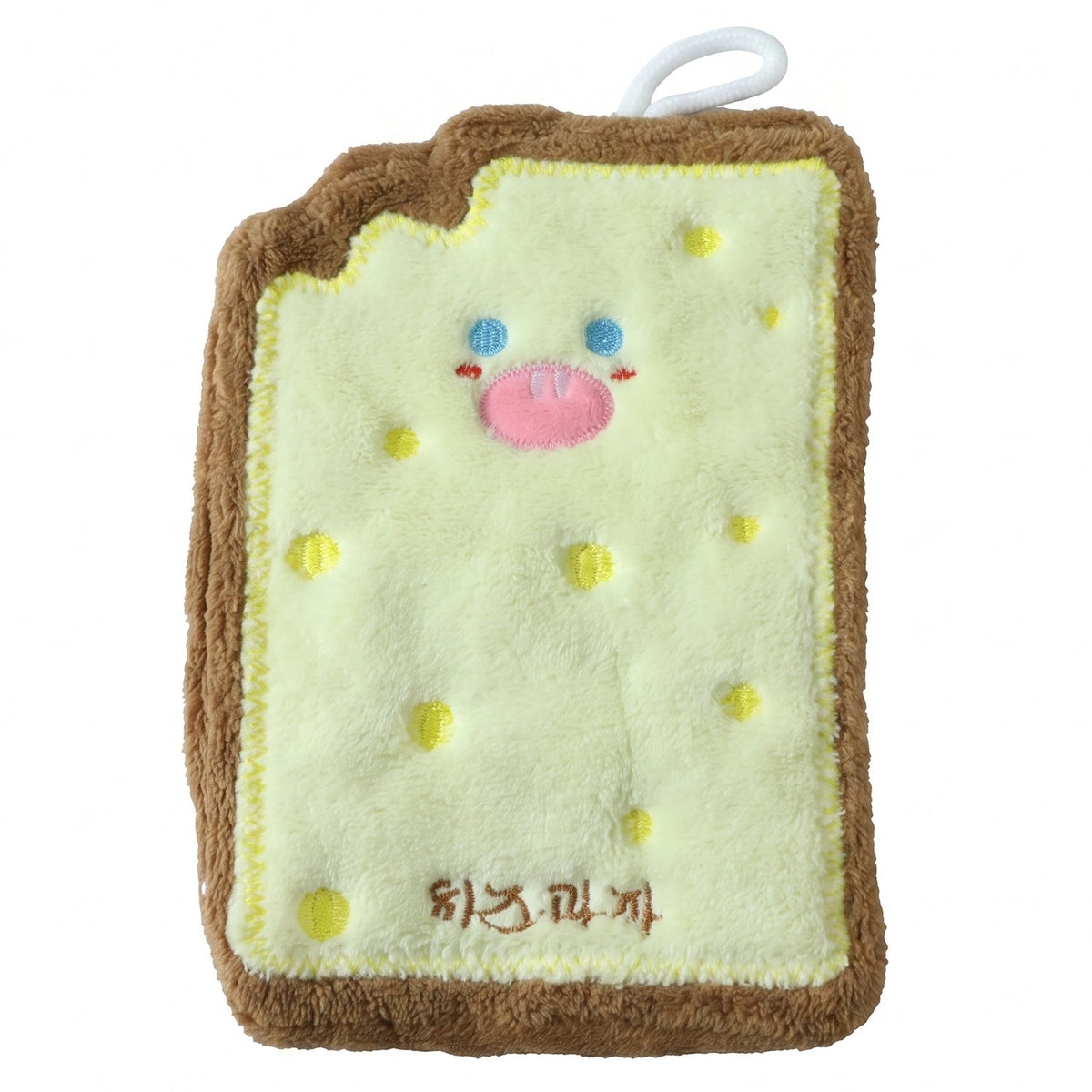 A cartoon cheese toast-shaped microfiber towel with a pink nose and blue eyes, and yellow dots, is displayed on a white