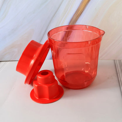 The red plastic corn cutter is disassembled, showing its transparent base and two red components on a light-colored