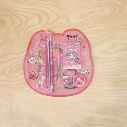 A pink rabbit-themed stationery set in clear plastic packaging, featuring a ruler, two pencils, a notebook, a pen, a