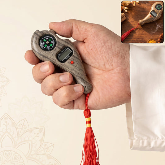 A hand holds a wooden digital tasbih counter with a compass and red tassel, with a small inset image.