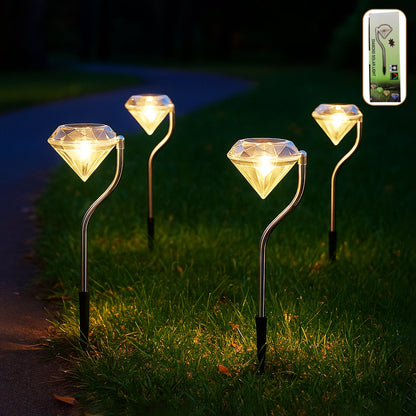 Four diamond-shaped solar lights illuminate a grassy path at night, with a remote control diagram in the corner.