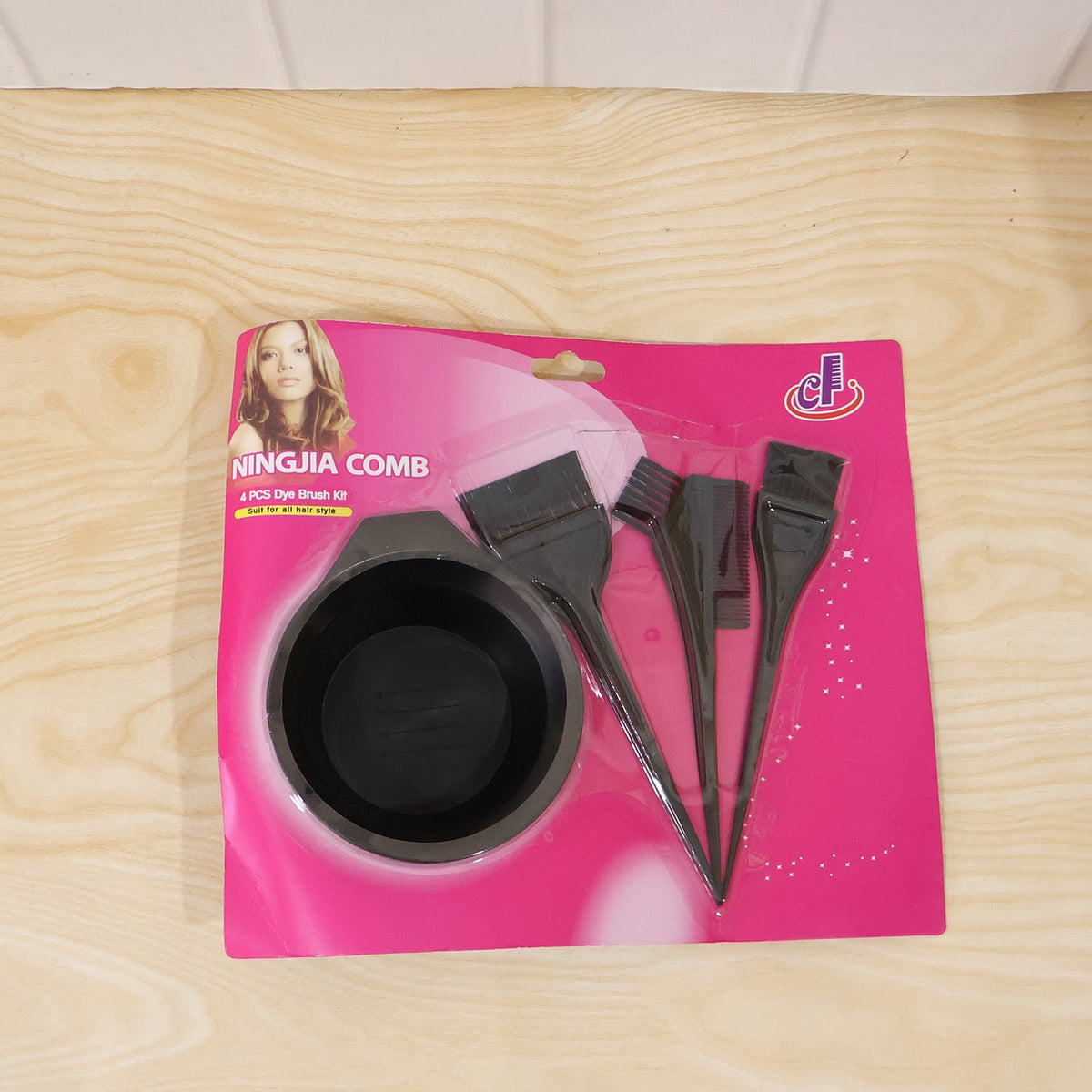 A pink and black packaged hair dyeing kit with a bowl and three brushes, labeled "NINGJIA COMB 4 PCS Dye Brush Kit".