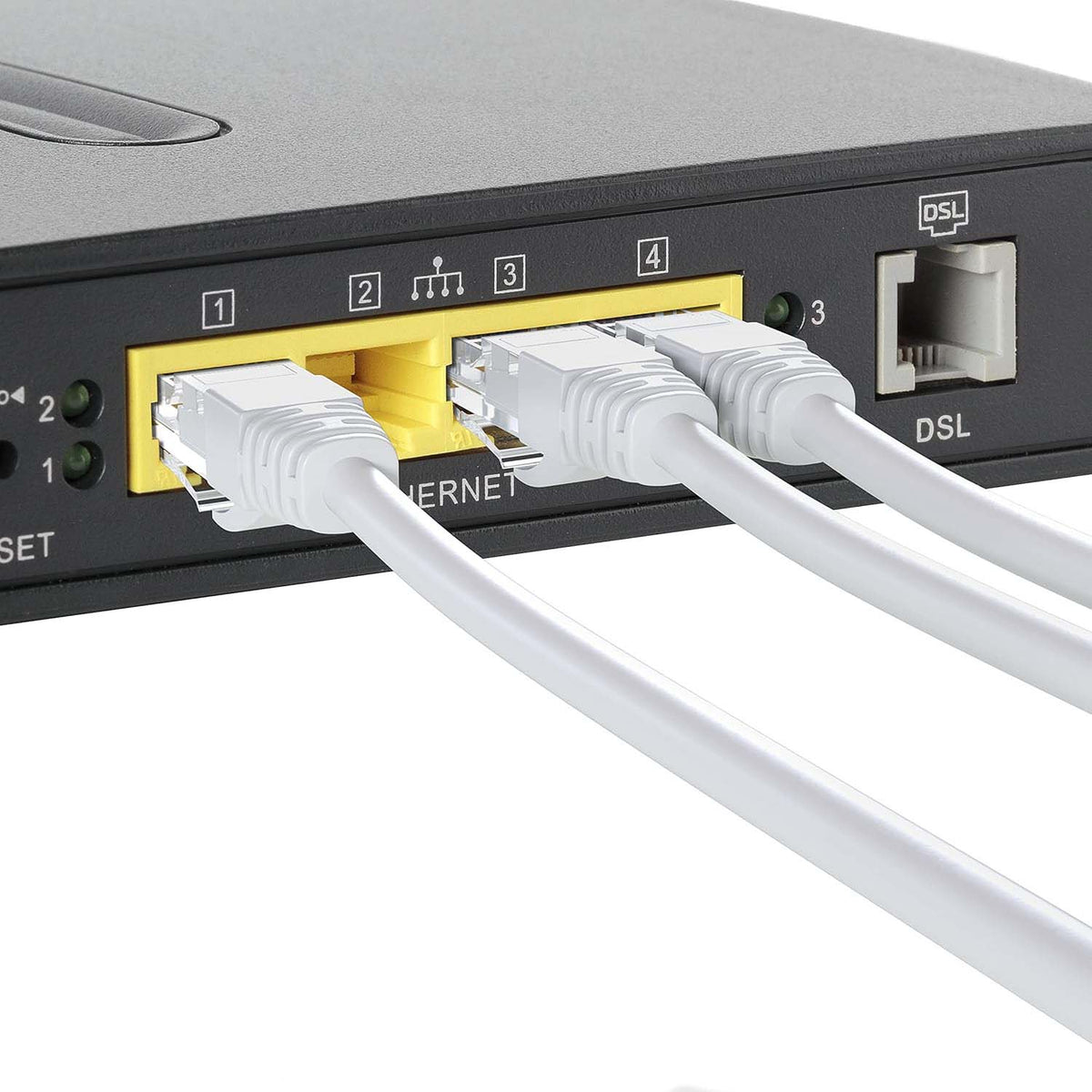 Three white ethernet cables are plugged into the yellow ports of a black router, showing a close-up of the connections.