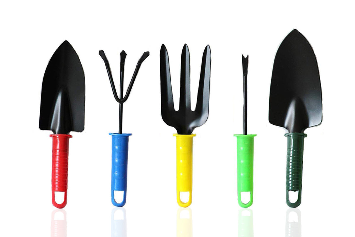 Five mini gardening tools with black metal heads and colorful plastic handles are lined up on a reflective white surface.