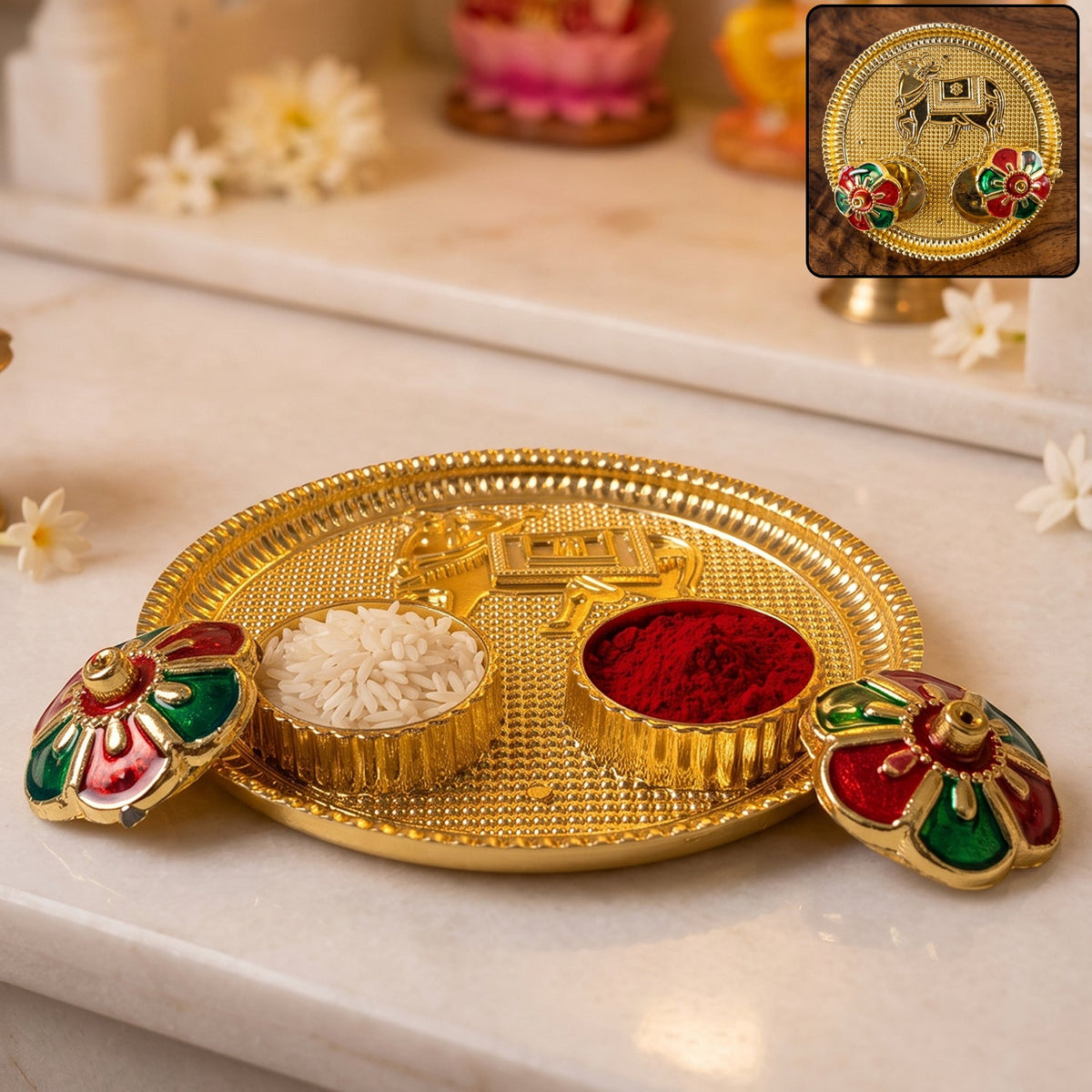 A golden pooja thali with a cow design, two small bowls of rice and kumkum, and two flower-shaped lids.