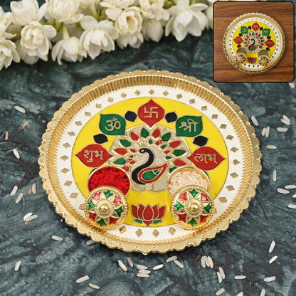 A yellow and gold puja thali with peacock design, small bowls of red powder and rice, with white flowers in the background.