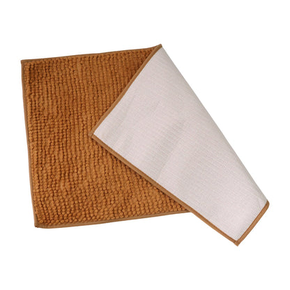 A brown rectangular bobble mat is partially folded to reveal its white, textured non-slip backing.