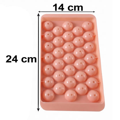 A pink plastic ice ball tray with dimensions 24 cm by 14 cm marked on a white background.