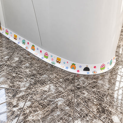 The cartoon-printed sealing tape is applied along the curved base of a white cabinet on a tiled floor.