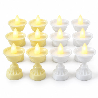 Twelve LED diya candles, six yellow and six white, are neatly arranged in rows on a plain white background.