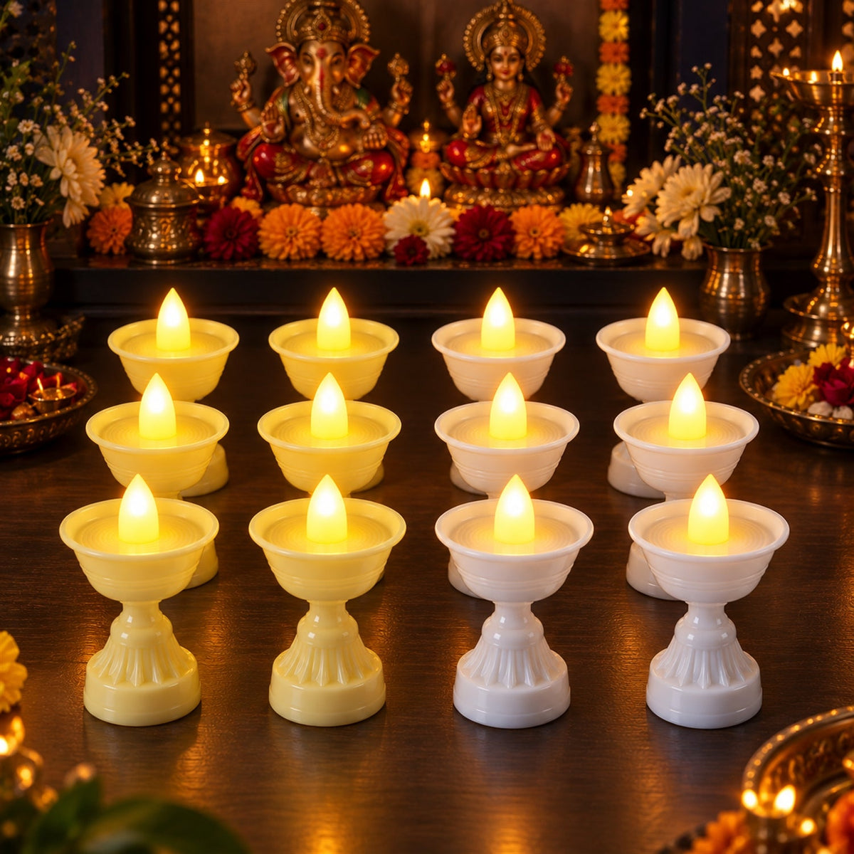 Twelve LED diya candles, six yellow and six white, illuminate a detailed wooden altar adorned with statues and flowers.