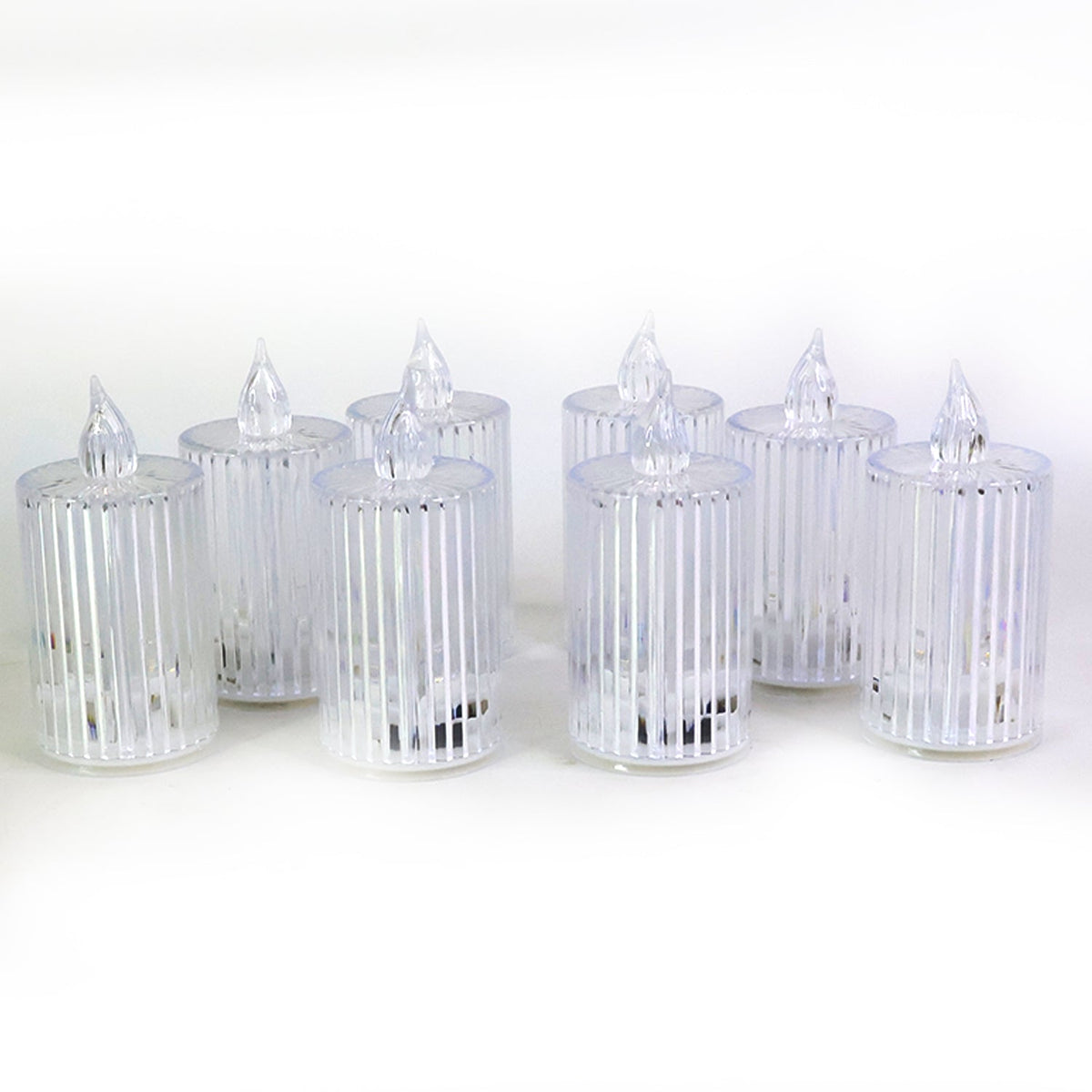 Eight clear ribbed LED flameless candles unlit, arranged on a plain white background.