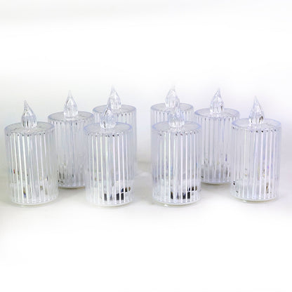 Eight clear ribbed LED flameless candles unlit, arranged on a plain white background.