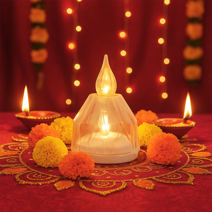 A single clear LED diya surrounded by orange and yellow marigolds, with traditional clay diyas and string lights.