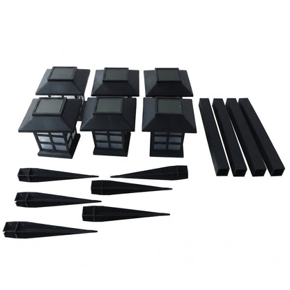 The unassembled components of six black solar garden lights are arranged on a white background.