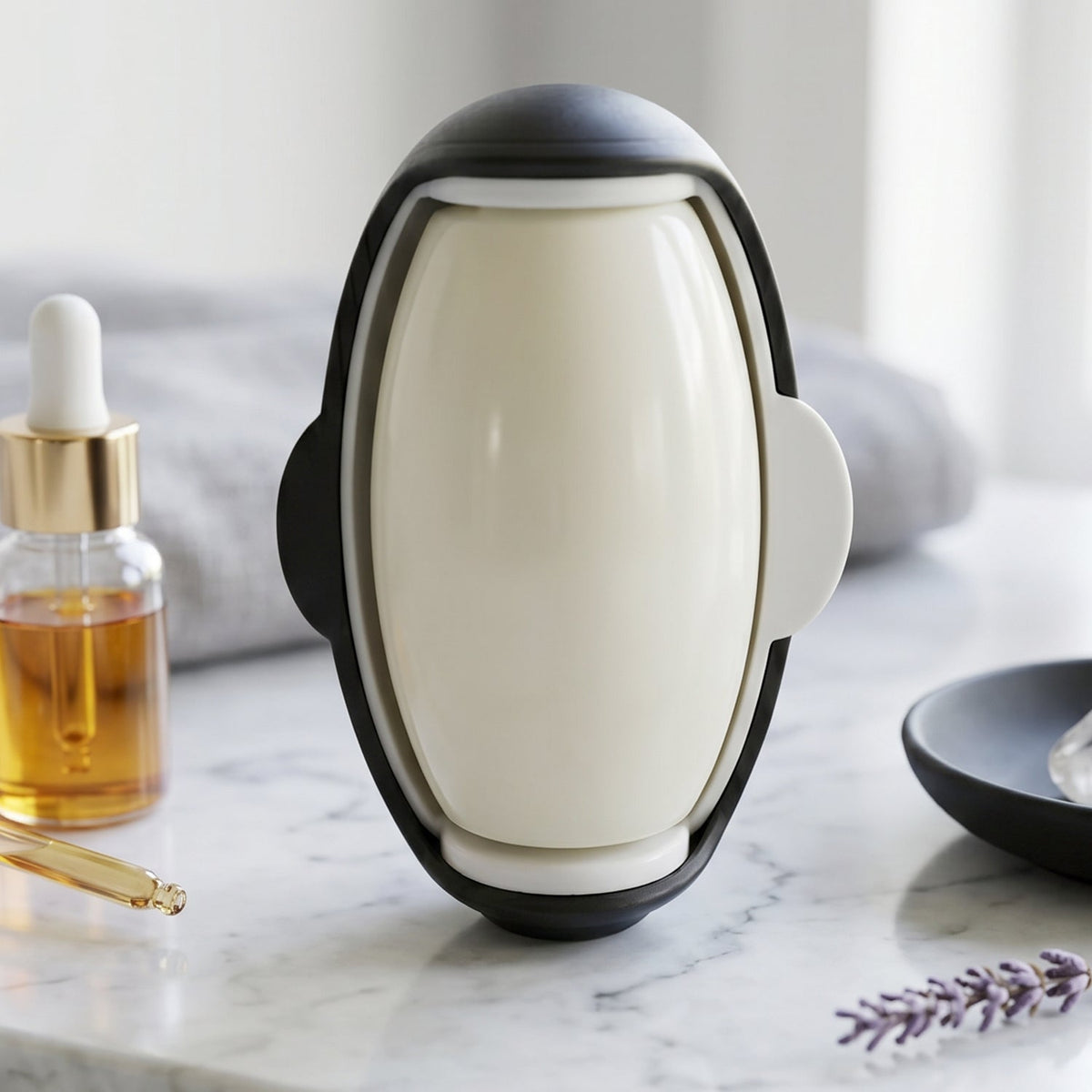 The black outer casing of the penguin lint roller is open, revealing the white lint roller inside on a marble surface.