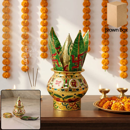 A golden metal Kalash with green leaves and a brown box in a festive setting