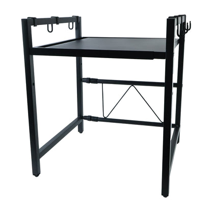 Black metal microwave oven rack with a single shelf and hanging hooks, viewed from an angle on a white background.