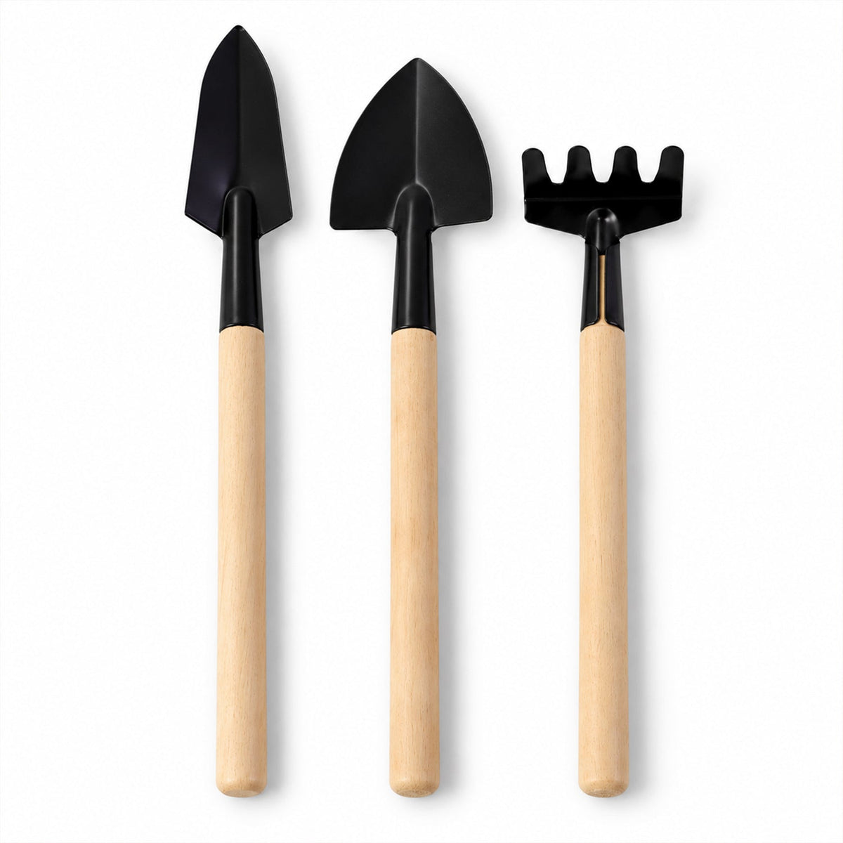 Three small gardening tools, including two trowels and a rake, stand upright on a plain white background.