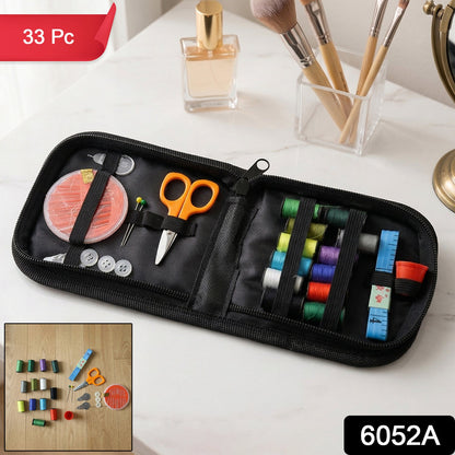 An open black sewing kit with colorful threads, orange scissors, and other accessories is shown on a white vanity with a '33
