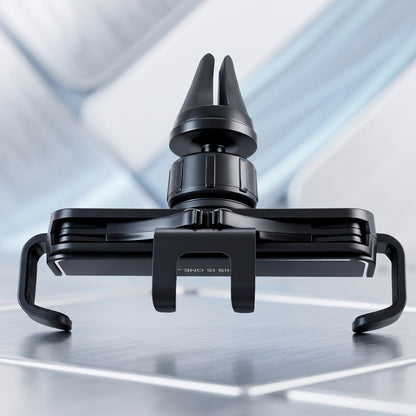 A close-up of the black plastic car air vent phone holder on a reflective surface.