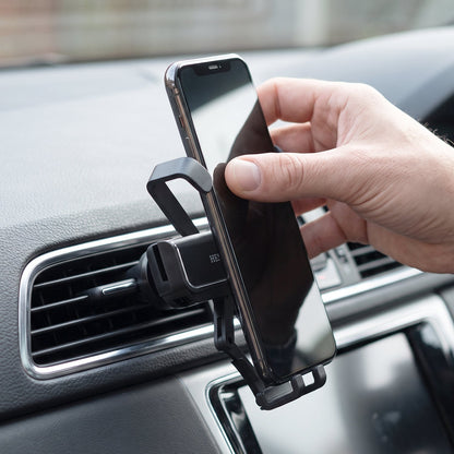 A hand removing a smartphone from a black car air vent phone holder attached to a car's vent.