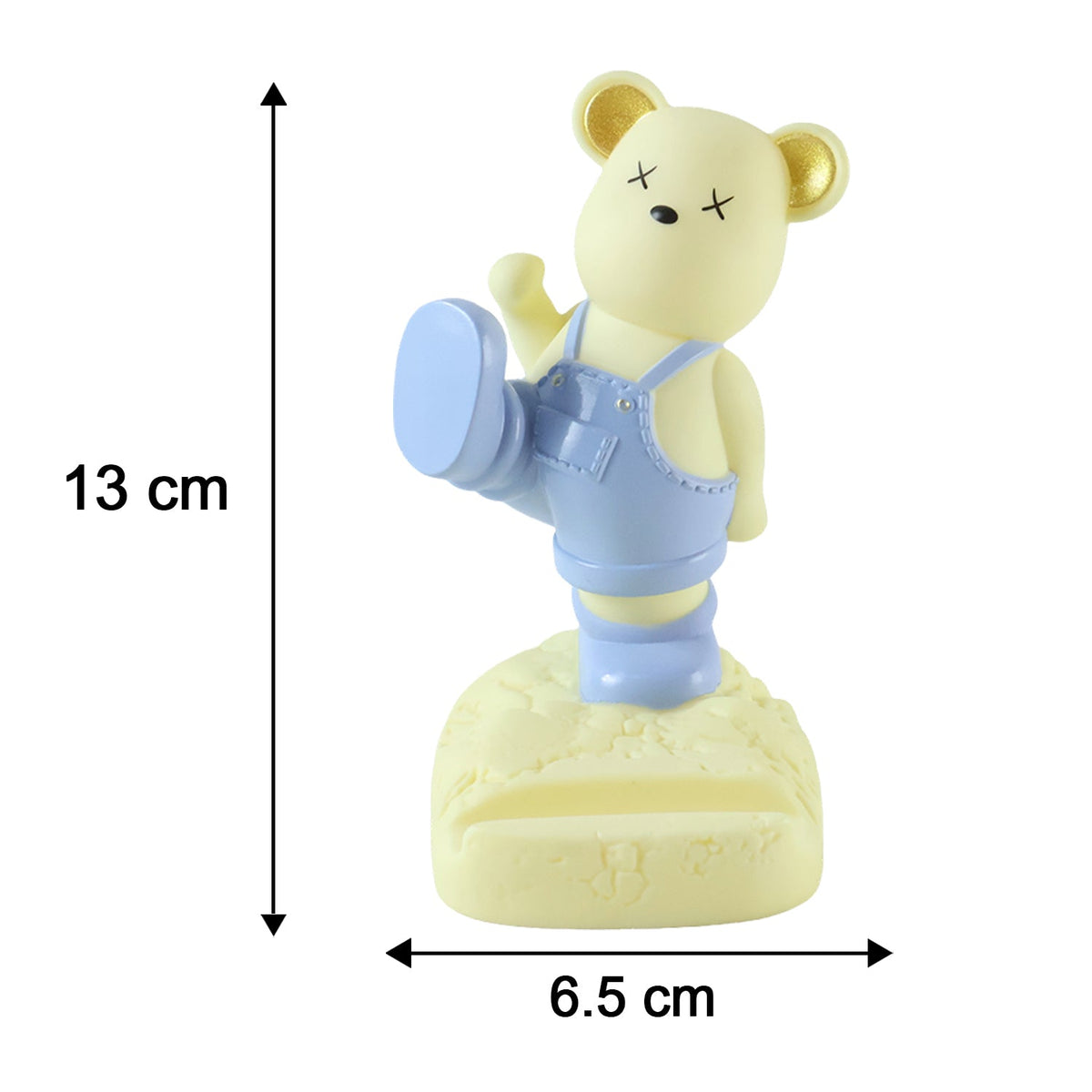 A yellow bear phone holder with blue overalls and gold ears, with dimensions 13cm by 6.5cm.