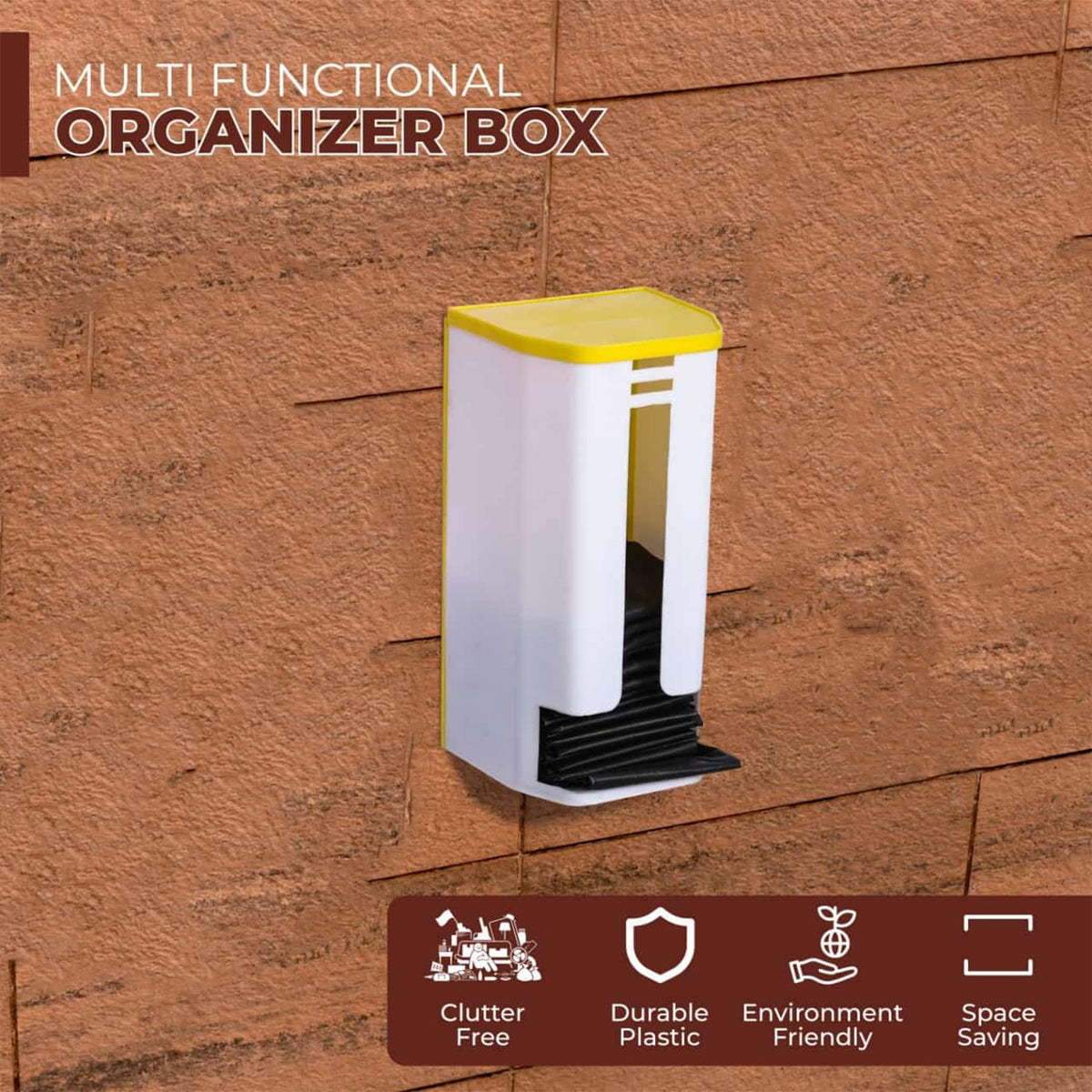 A white and yellow plastic bag dispenser with black bags inside is mounted on a textured brown wall.