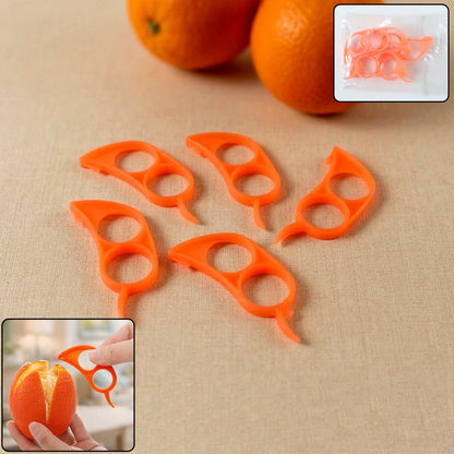 Five orange plastic citrus peelers are arranged on a light brown surface with two oranges in the background.