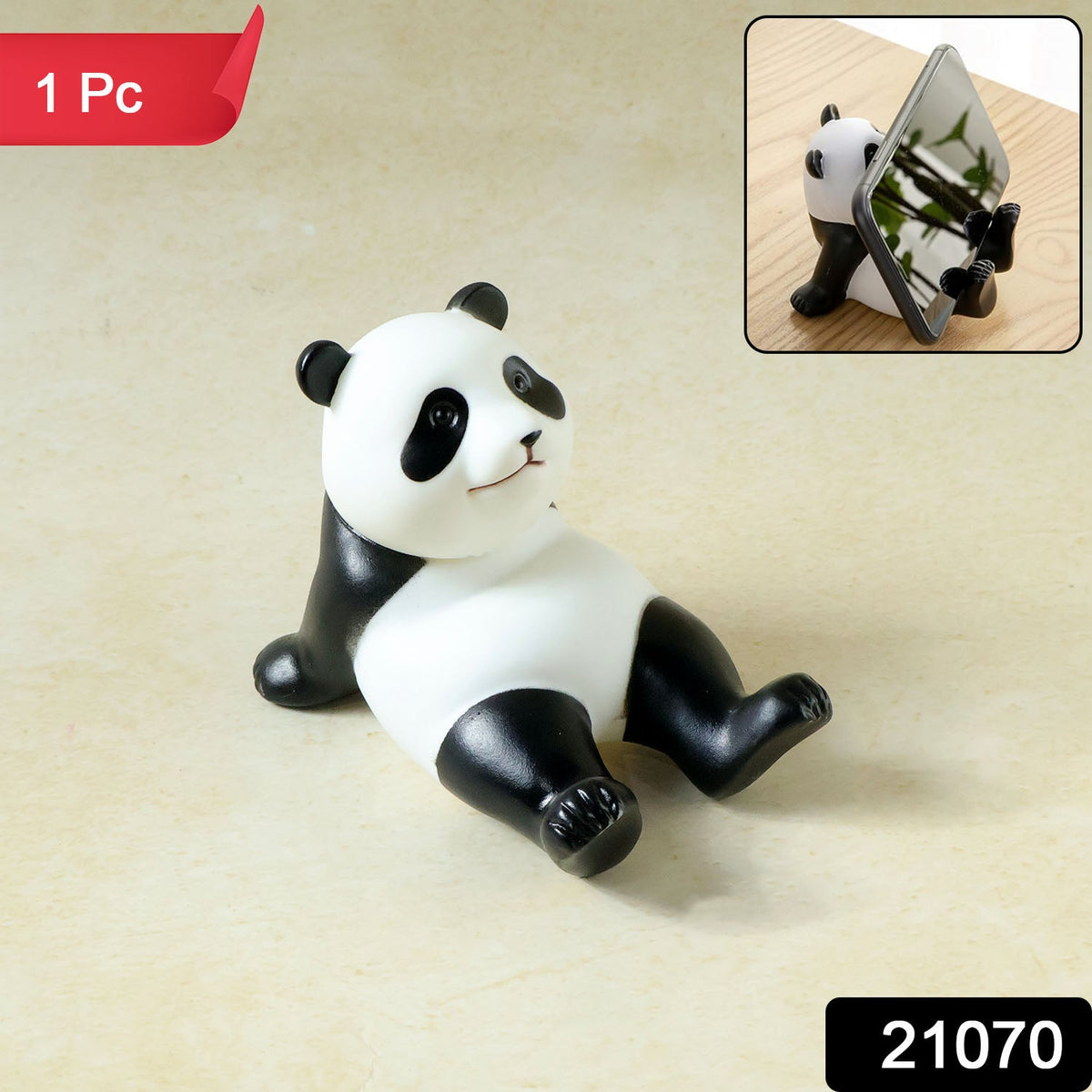 A black and white panda figurine with a small smile sits on a light brown surface. Inset shows the panda holding a phone.