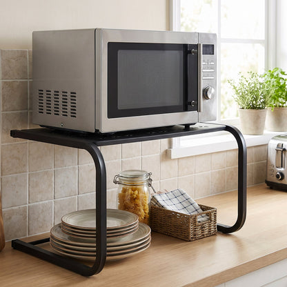 Microwave stand with utensils stored on the lower shelf