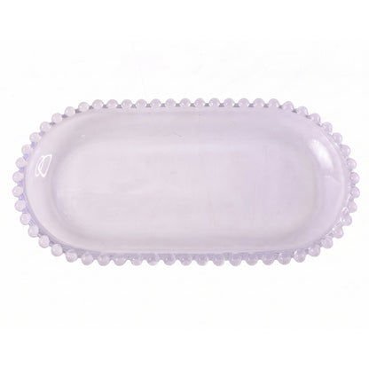 A transparent oval glass tray with a textured beaded border is shown on a plain white background.