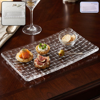 Clear glass rectangular serving tray with a basketweave texture, holding appetizers and a small bowl of crackers.