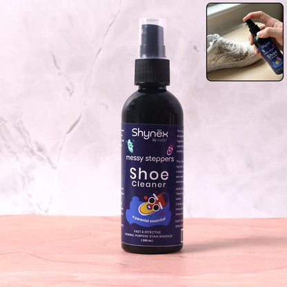 A Shynex shoe cleaner bottle stands upright on a pink and white surface, with a small inset of a hand spraying a shoe.