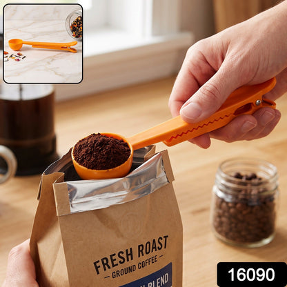 An orange plastic scoop with ground coffee is held over a bag, with a jar of coffee beans nearby and the number 16090.