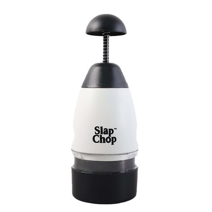 The white and black manual food chopper is centered on a plain white background, showcasing its design.