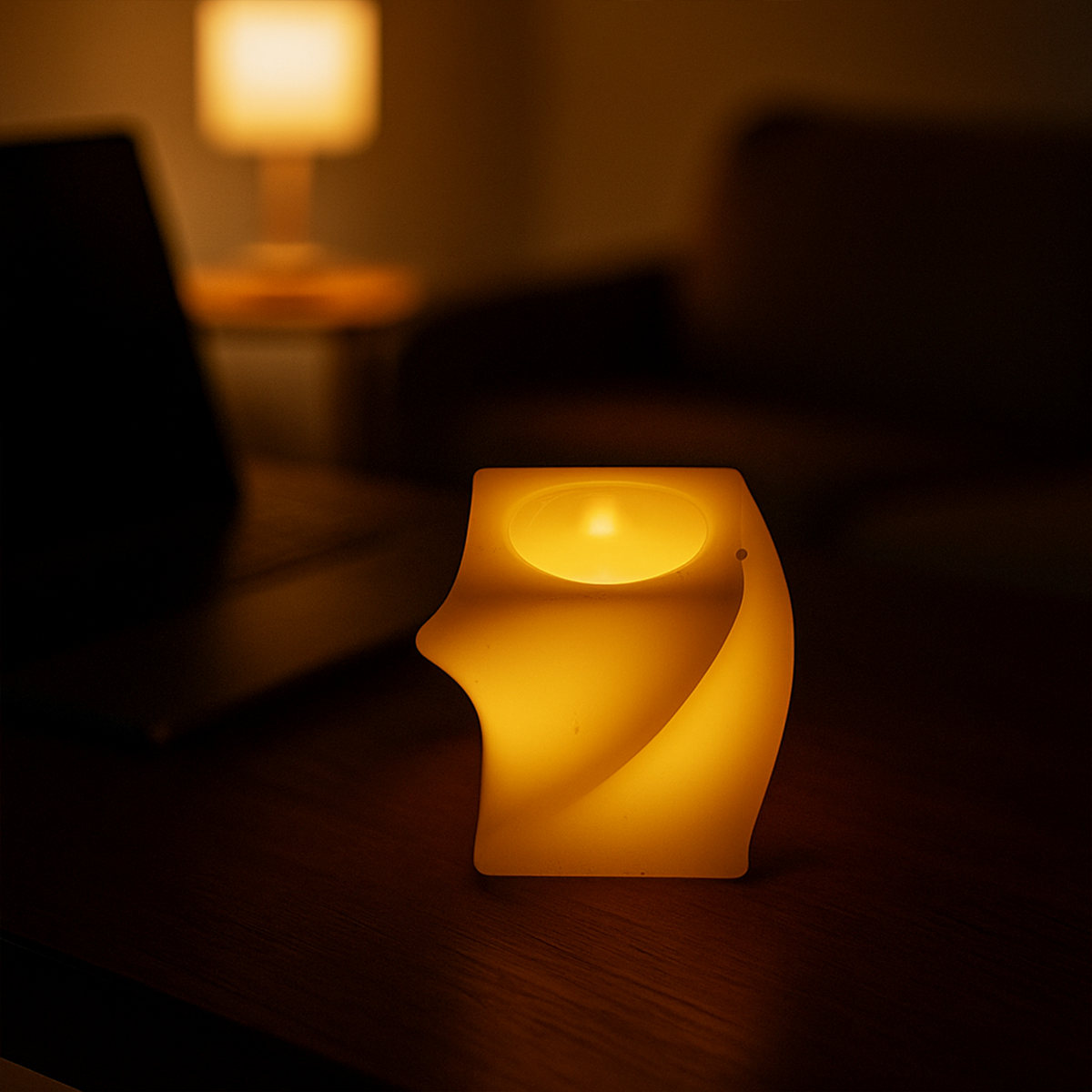 A single cream-colored flameless LED candle with a twisted design illuminates a dark wooden table in a dimly lit room.