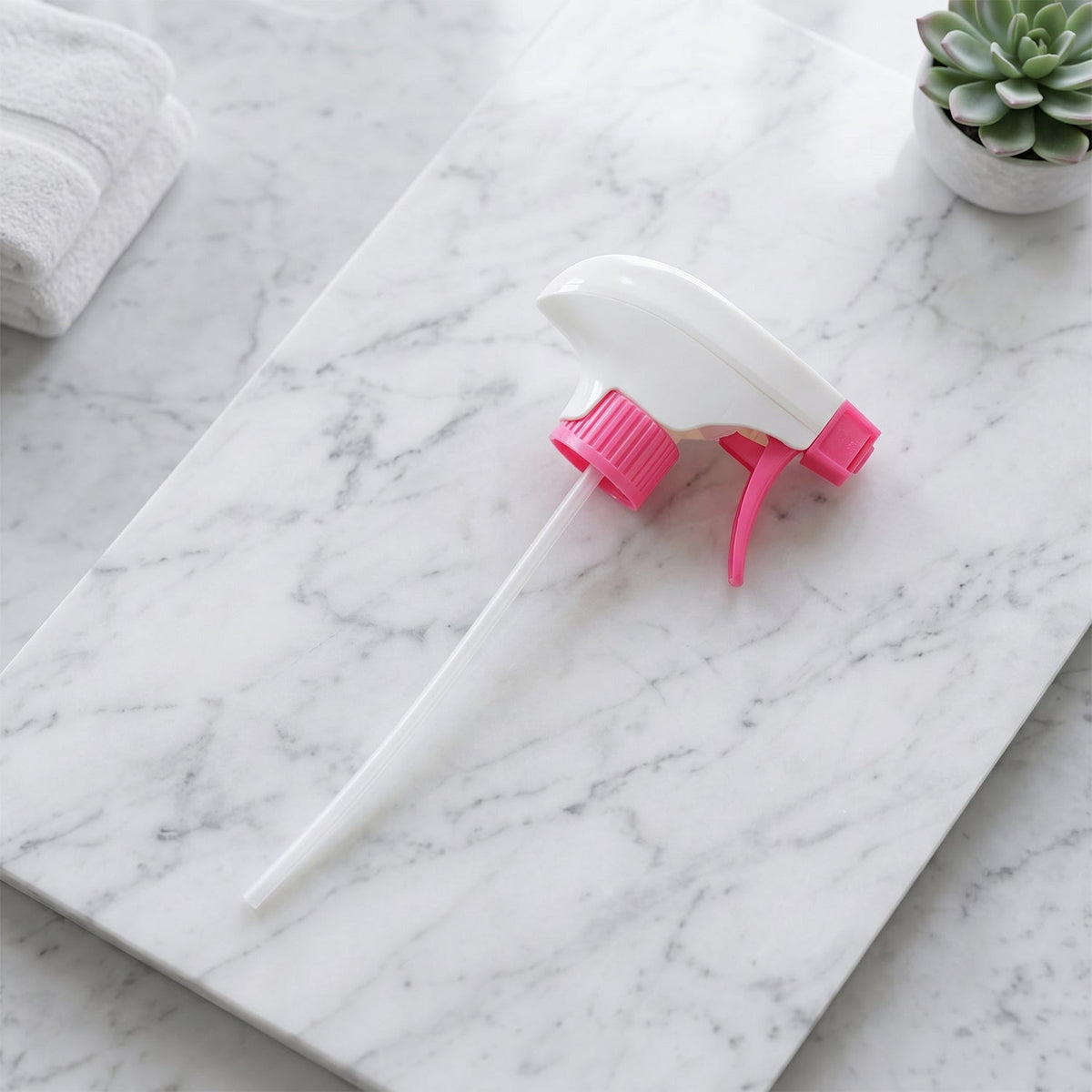 Pink trigger sprayer fitted to a spray bottle