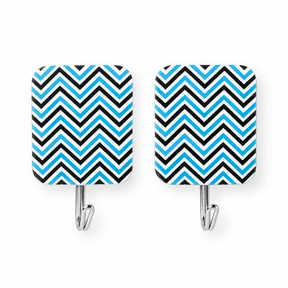Two identical rectangular adhesive hooks with a blue and black chevron pattern are shown on a plain white background.